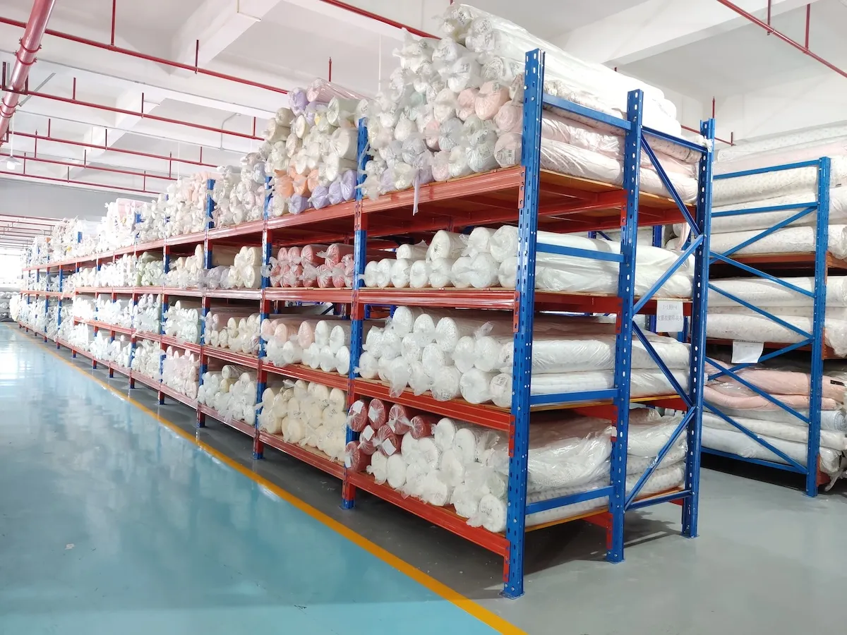 Fabric warehouse with rolled and verified stock ready for cutting