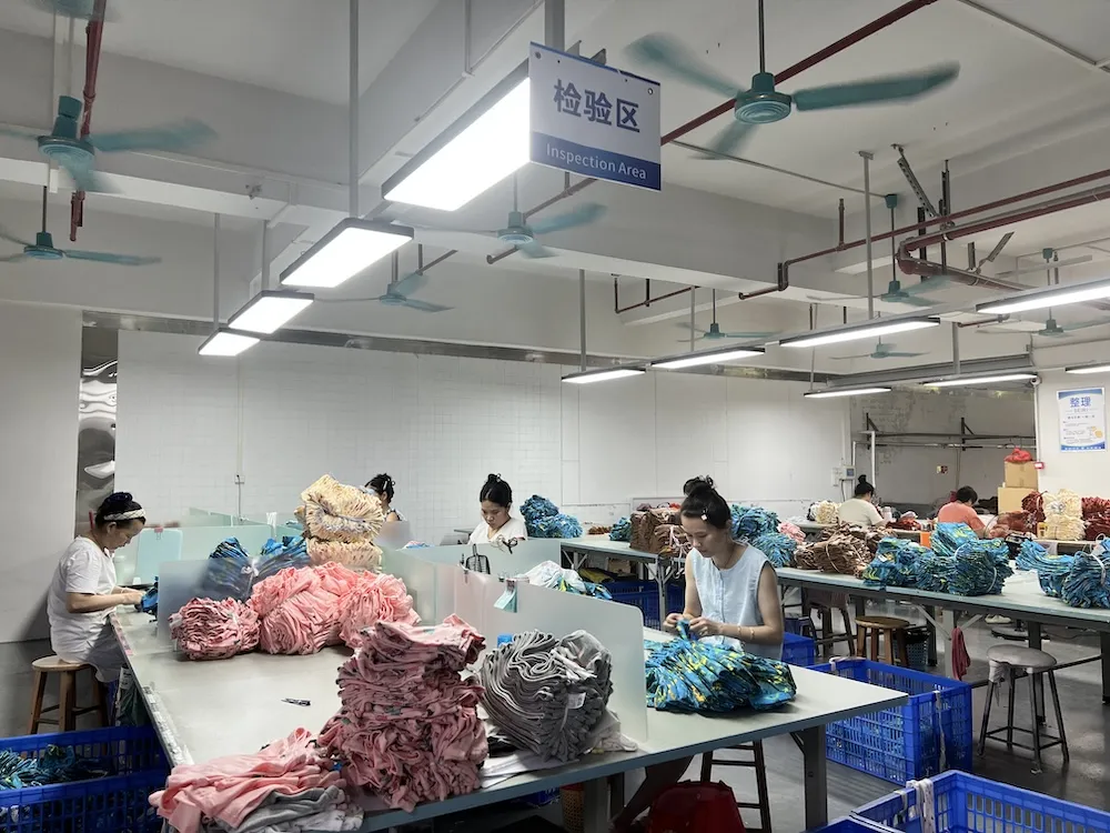 Final inspection and needle-detection station for kids' apparel