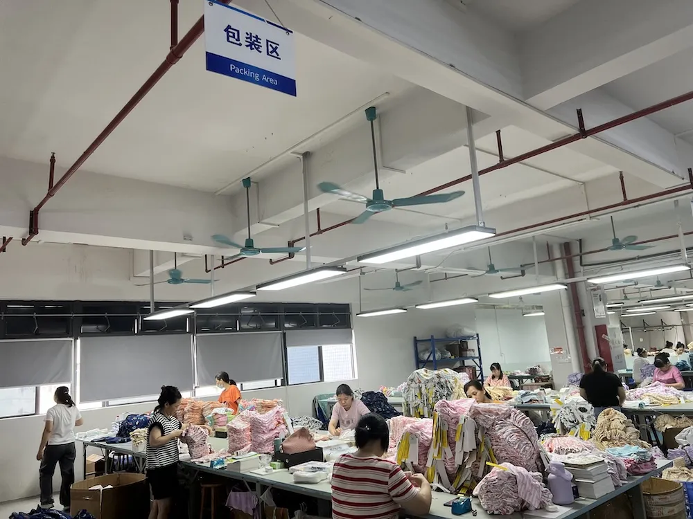 Packaging area folding, polybagging and cartoning finished garments