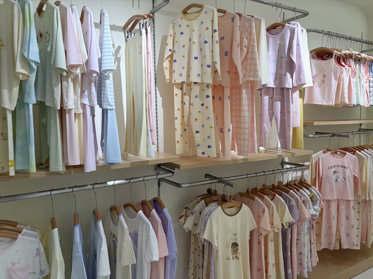 Racks of kids sleepwear and loungewear sets in assorted prints for private label orders