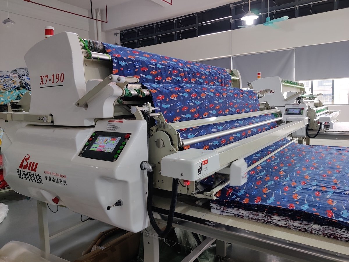 Fabric spreading machine preparing cotton knits for cutting