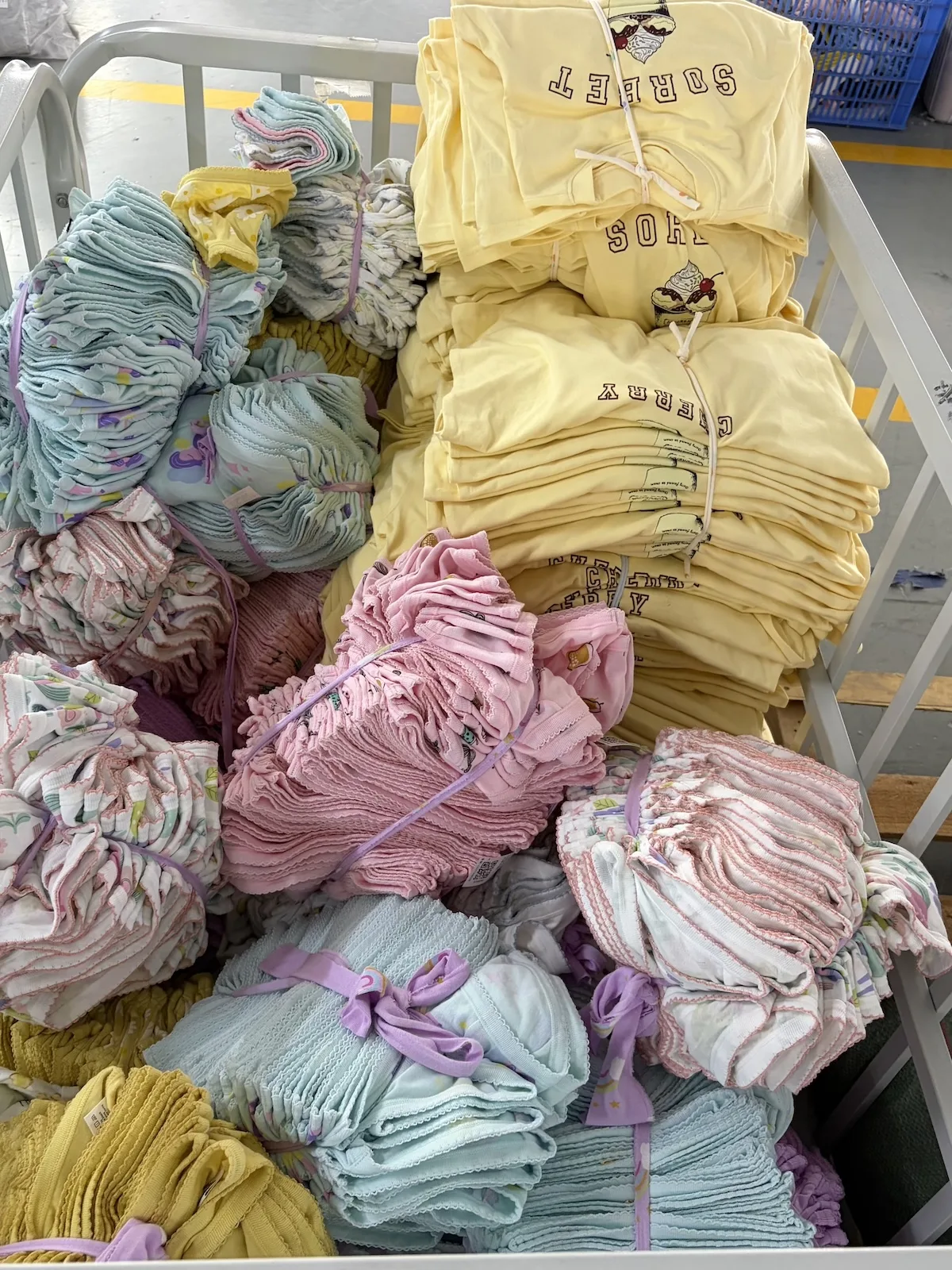 Bundles of coloured knit fabric in various solid shades