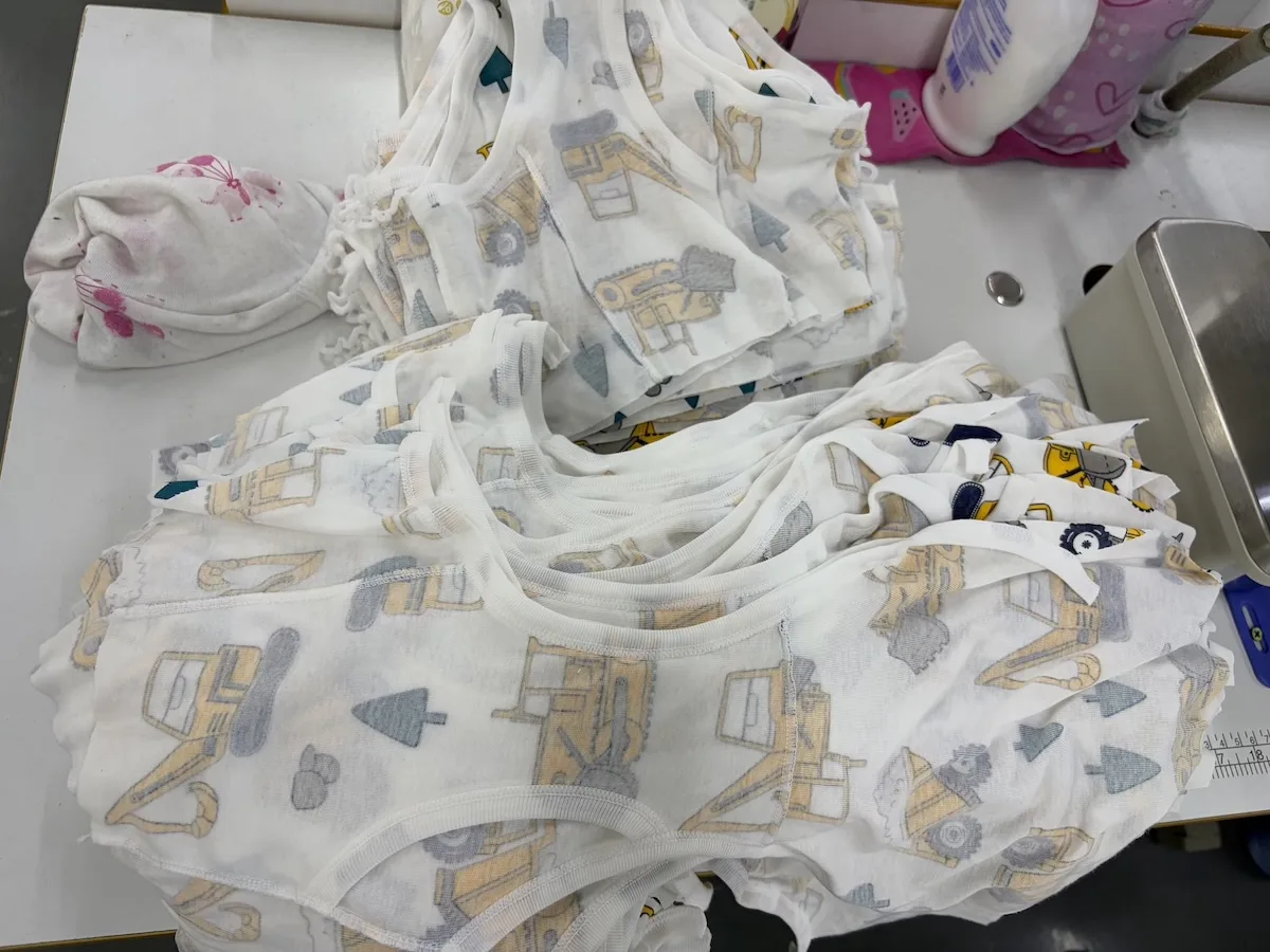 Final inspection table where finished printed kids' garments are checked