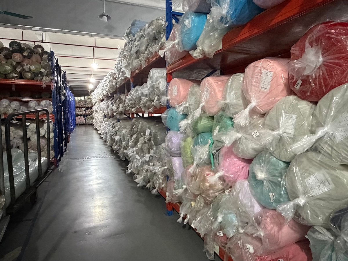 Rolls of printed and plain kidswear fabrics used for color matching
