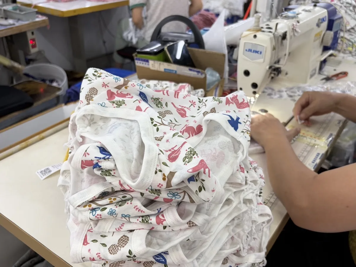 Hand finishing of a soft bound seam on children's underwear