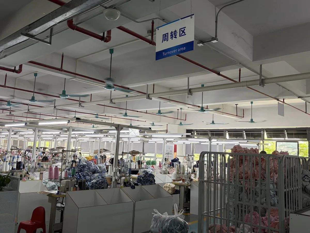 Quality check area with inspected kids' apparel on a rail