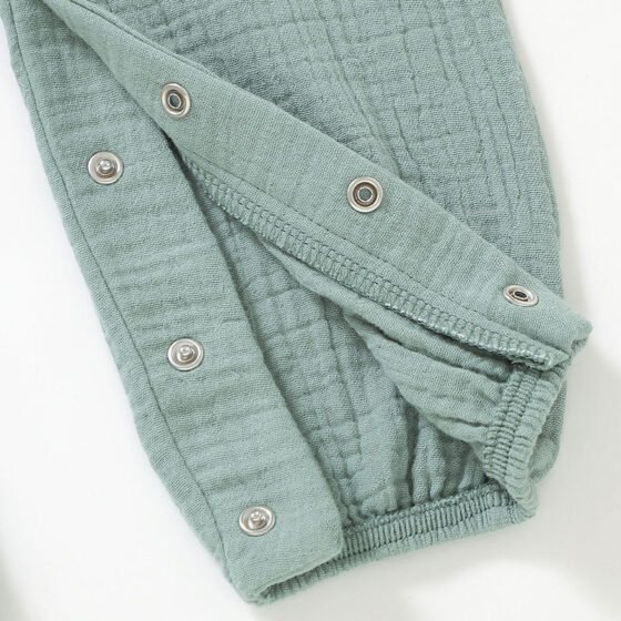 Close-up of the hidden snap button crotch detail on a baby romper