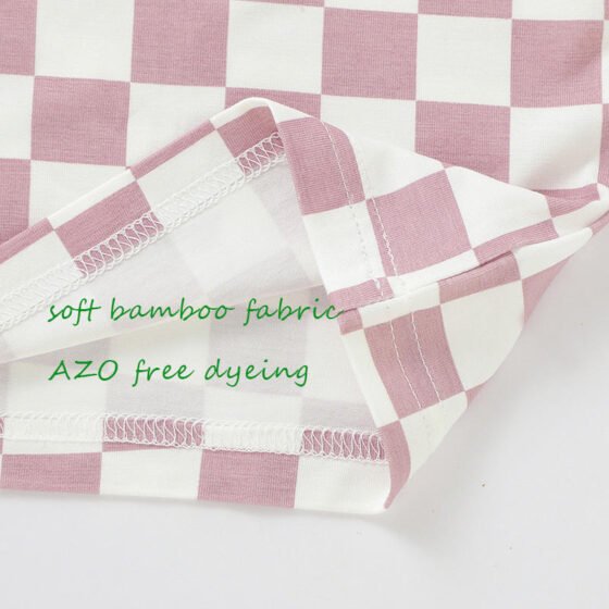Close-up of checkered bamboo baby pajama fabric and internal seam construction