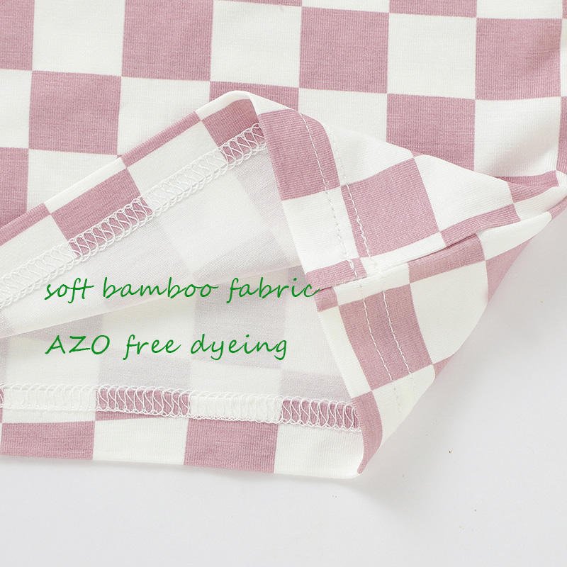 Close-up of checkered bamboo baby pajama fabric and internal seam construction