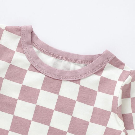 Close-up of pink checkered baby pajama neckline and stitching construction