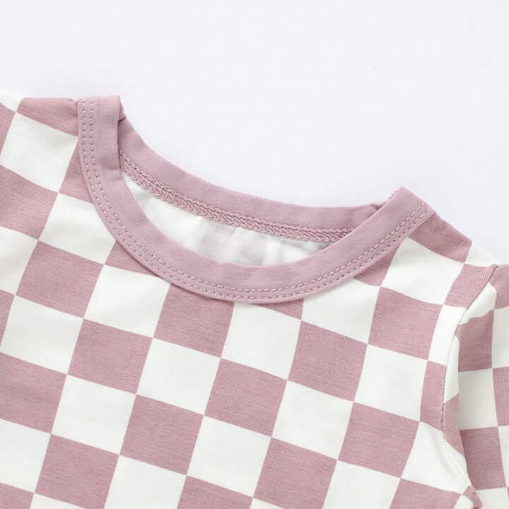Close-up of pink checkered baby pajama neckline and stitching construction