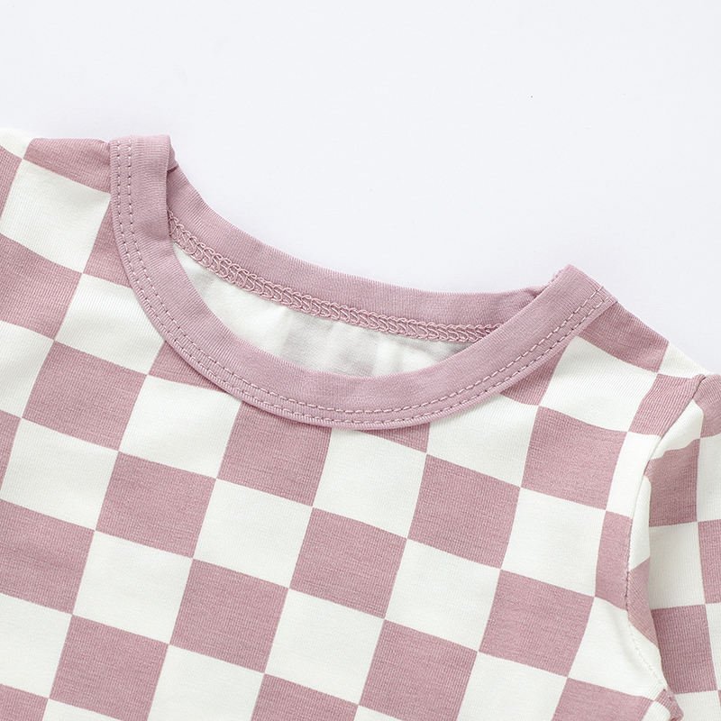Close-up of pink checkered baby pajama neckline and stitching construction