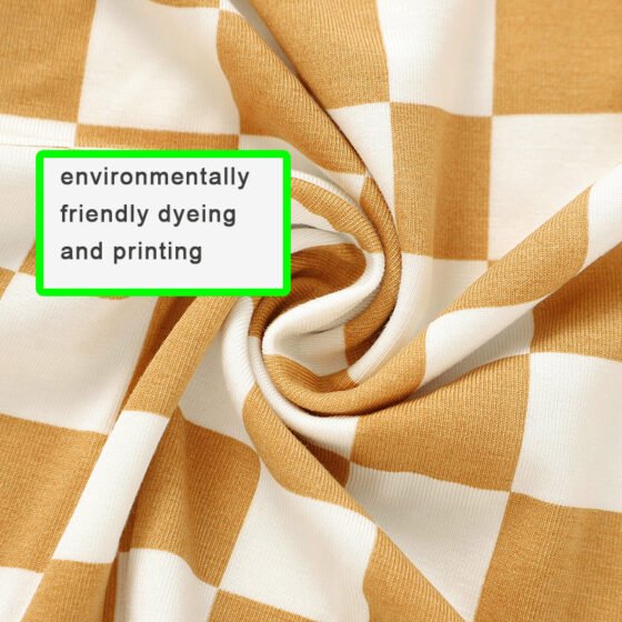 Close-up of mustard and white checkered bamboo viscose jersey fabric showing print and knit texture