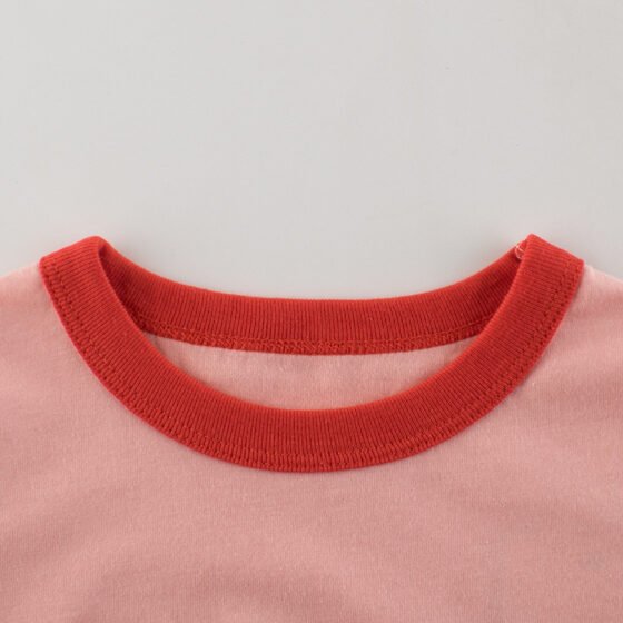 Close-up of red contrast ribbed crew neckline on girls cotton cherry t-shirt