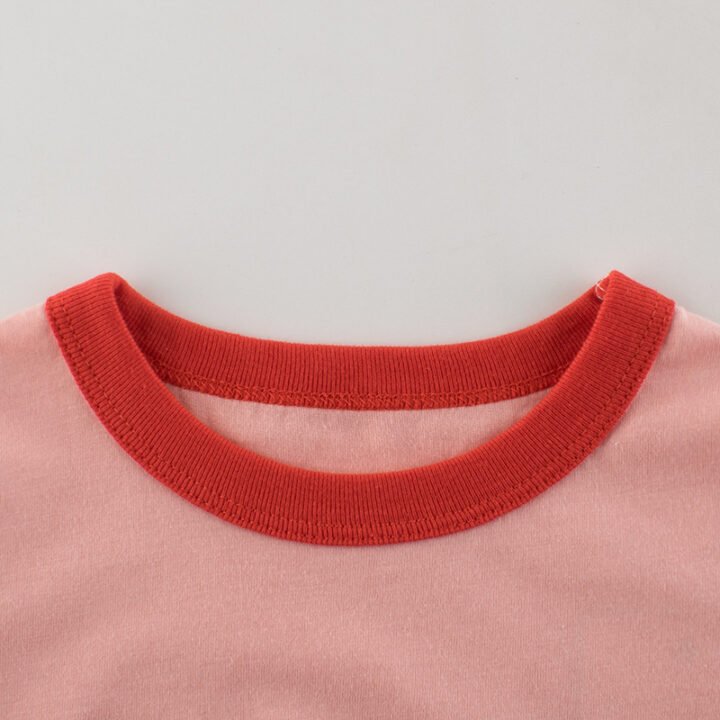 Close-up of red contrast ribbed crew neckline on girls cotton cherry t-shirt