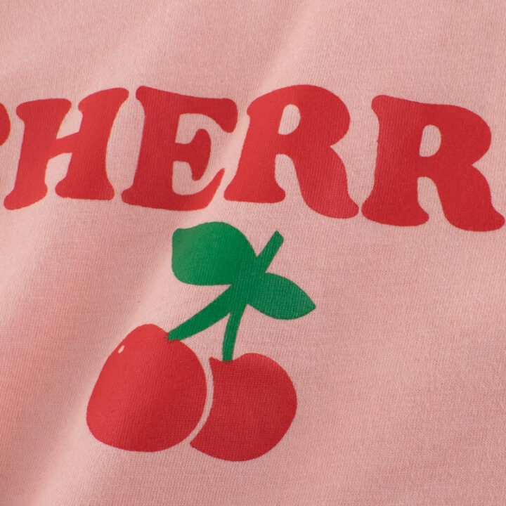 Close-up of CHERRY text and cute red cherry graphic print on cotton kids t-shirt
