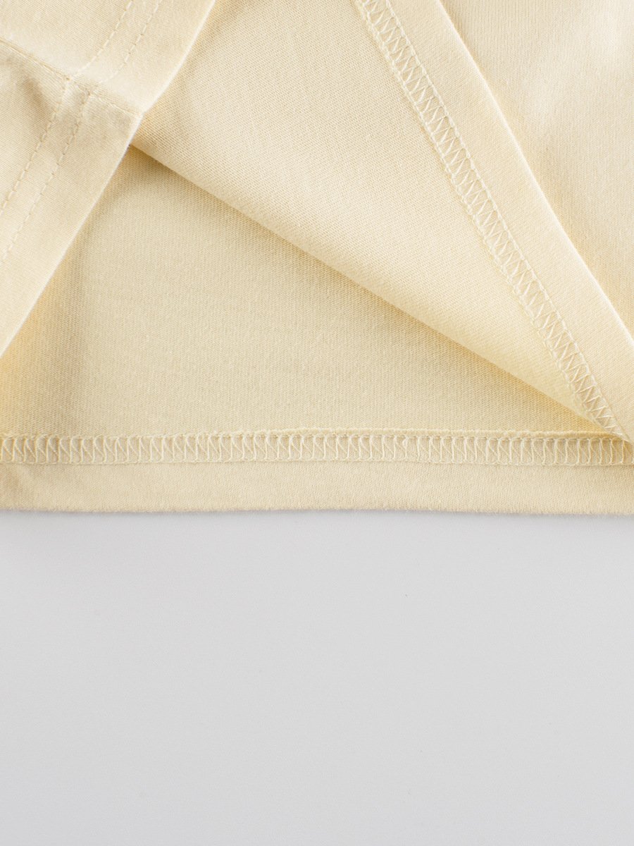 Close-up of the double-needle bottom hem on a blank kids cotton t-shirt