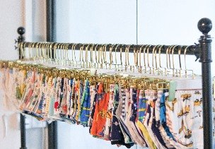 Kidswear sample room with hanging racks of finished samples at Nuohua Garment