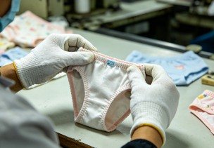 Quality inspection of a finished kidswear garment before packing