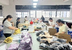 Packing and bagging kidswear orders at the packing station