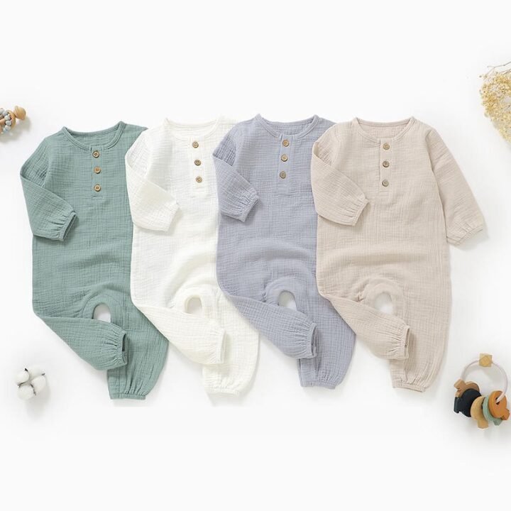 Four color options of long sleeve muslin baby jumpsuits displayed flat