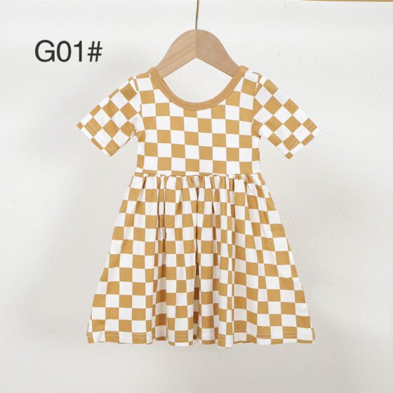Mustard and white checkered bamboo viscose girls dress G01 displayed on a wooden hanger