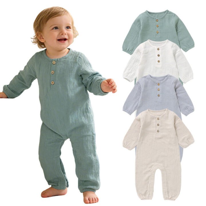 Toddler wearing a sage green organic cotton muslin baby romper