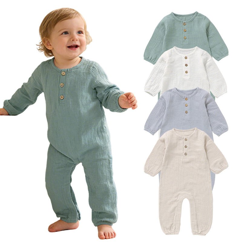 Toddler wearing a sage green organic cotton muslin baby romper