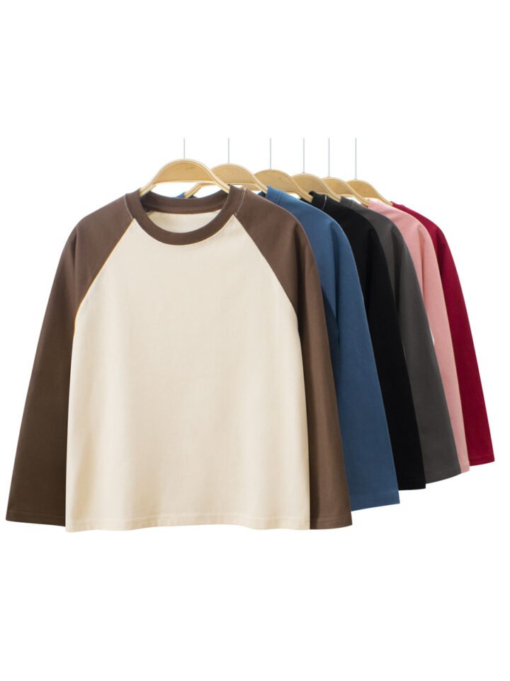 Multiple colors of blank kids long sleeve raglan t-shirts on hangers for wholesale